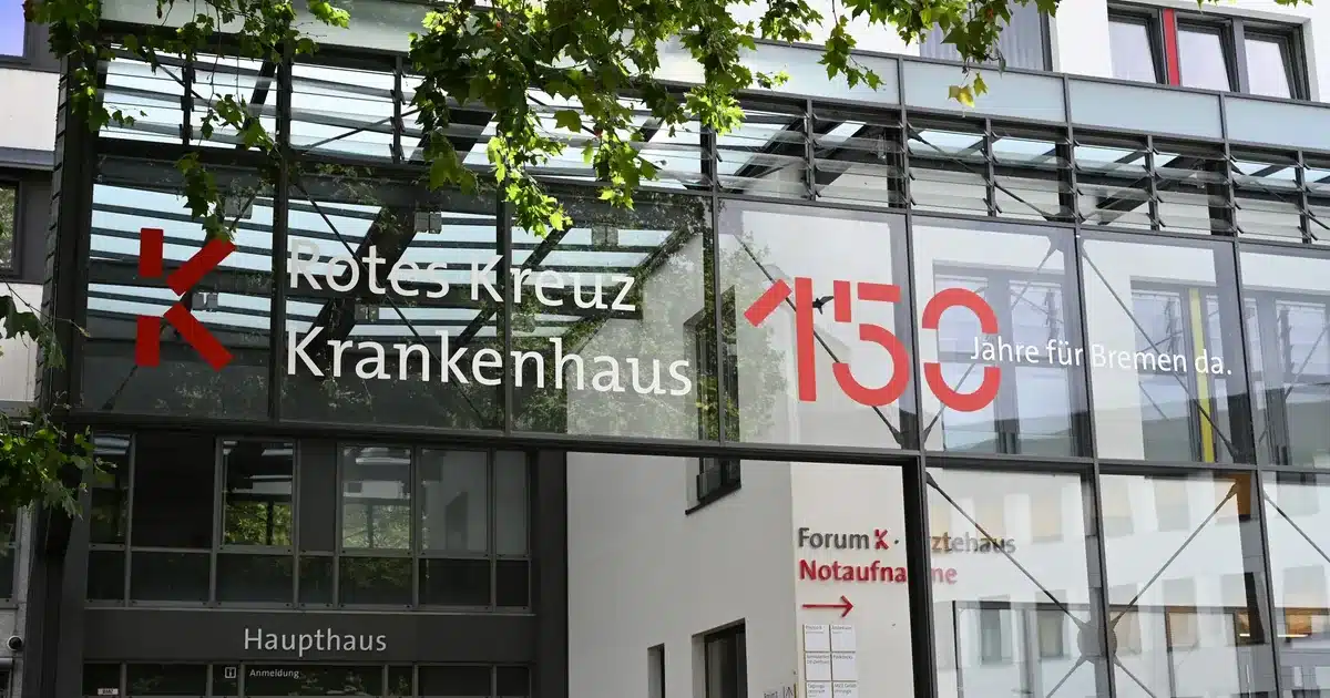 Gläserner Haupteingang des Rotes Kreuz Krankenhauses mit Hinweis zur Notaufnahme